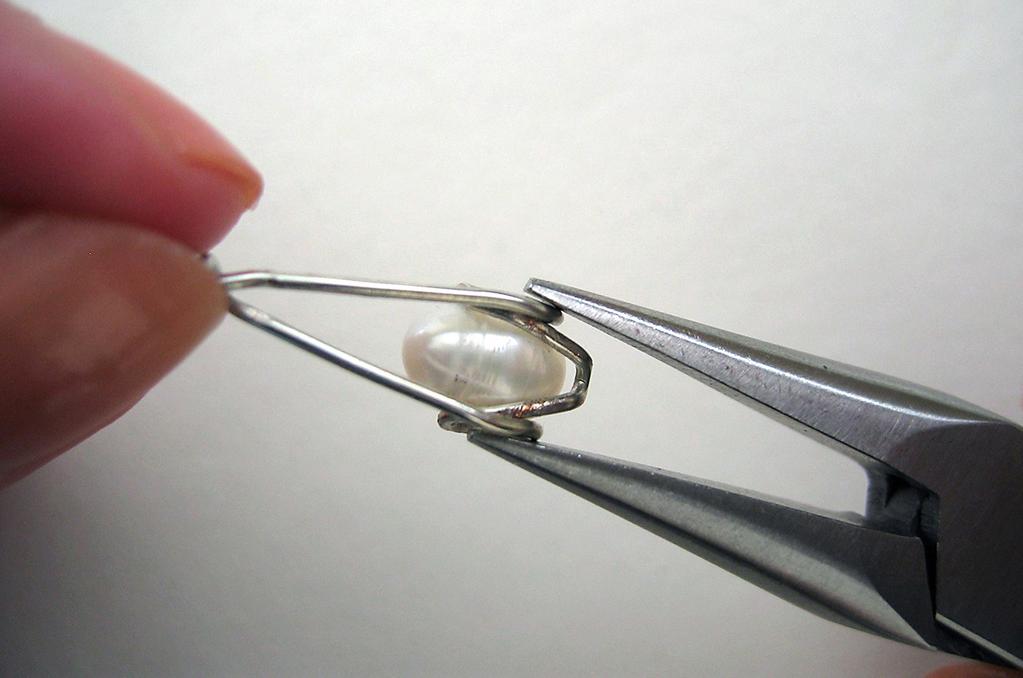 pearl. Use roundnose pliers to bend the non-loop end up slightly toward the loop end [18].