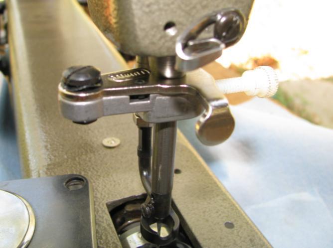 6.) Look at the needle as it extends into the area where the bobbin and case normally are.