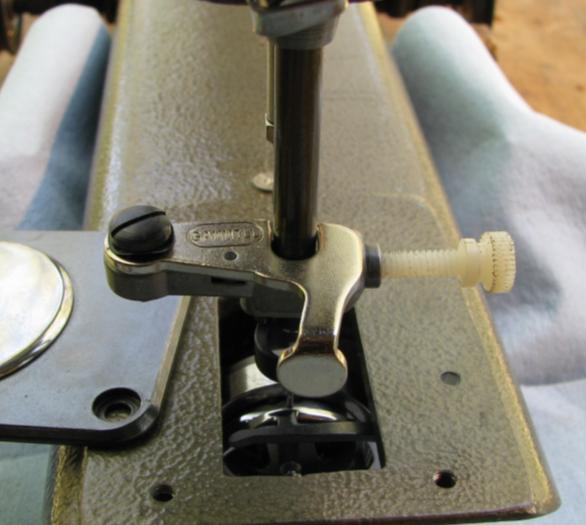 Rotate the pivoting leaf to the closed position, and rotate the hand wheel clockwise so the needle is at its lowest point.