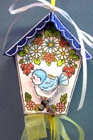 ornament size bird cottage, with its winged duo, is sure to please. It can hang as a decoration, hold potpourri or become a charming miniature gift box.