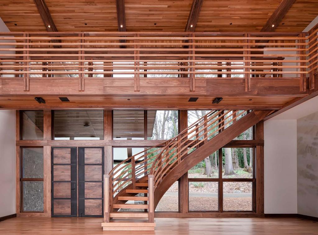 Aesthetic value: Modern stair design plays off the exterior forested environment mixing local wood materials and utilizing traditional joinery; the light shining in from this open style modern home