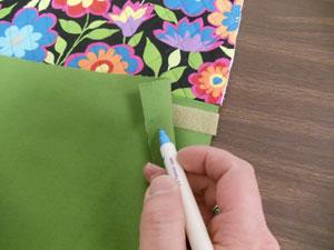 Spray the back of the Velcro with adhesive, smooth it in place, and sew a seam along the edges of the Velcro.