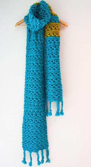 Insert crochet hook through RS of scarf edge; lay yarn at the folded point over the hook. Pull yarn through, from back to front, just enough to create loop.