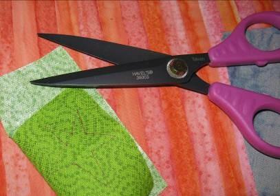 Use a big tapestry needle to thread purple metallic ribbon through