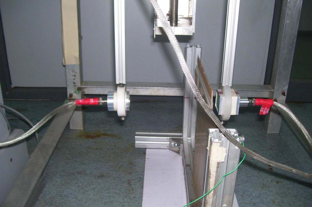 Figure 3: Experimental setup for air-coupled ultrasonic inspection of steel-rubber specimen A 900 volts square wave pulse was used to generate the excitation signal.