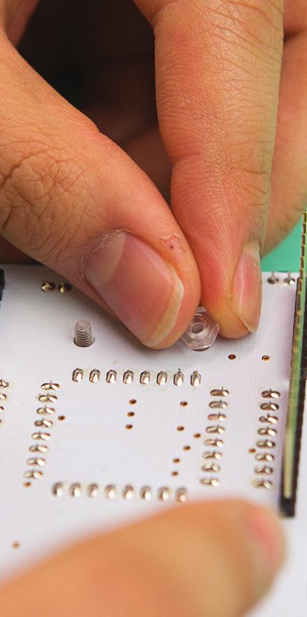 With the spacers in between the acrylic and PCB, slot the two bolts into the holes at the top of the