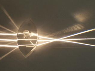 A lens forms an image by refracting light rays that pass through it.
