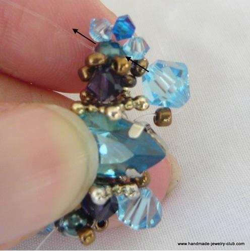 Blue Swarovski Bicone Crystal and 1 seed bead.