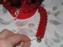 To make legs thread red beads along each