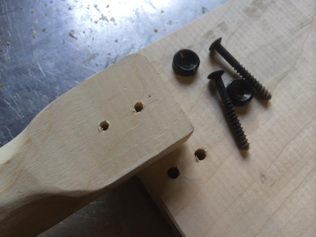 Drill holes for the pickup mounting ring. 5. Drill two holes for the neck mounting screws. They will be 1/2 and 1 1/4 inches away from the edge of the body.