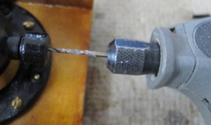 The screw head should be on the bottom as the screw threads upward.