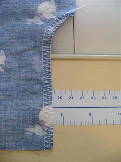 Serge arm hole opening (use tail left in step above to feed seam through serger, trim tail before seam goes