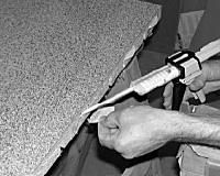 Pull up the black loading arm on the top of the gun, insert the adhesive cartridge and click the loading arm back into position. Do not cut the end of the nozzle.