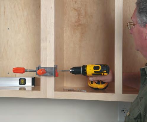 2 Locate the wall studs in the area where you intend to hang the wall cabinet, using a stud finder.
