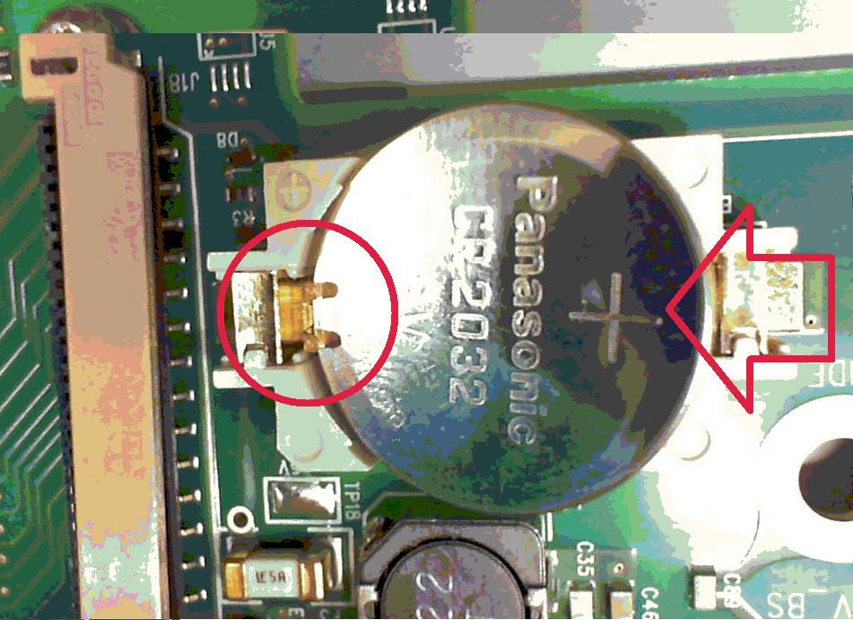 Place the battery under the small spring clips closest to the ribbon cable connector, then push down on the opposite end of the battery to seat the battery (see red arrow below).