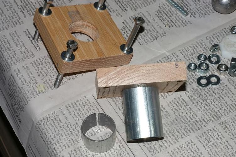 A piece of 1-1/4" EMT tubing a few inches long is inserted into an oak board to make the forming tool.