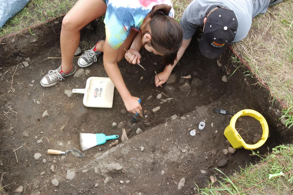 Cornell University Field School students excavate a large Seneca pit feature,