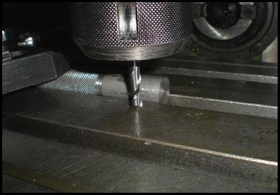 Set handle on mill bed T-slot using a clamp.