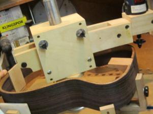 When routing the back (as here), the top of the frame is face down in the jig.