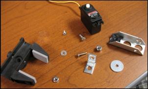 Step 16 Now gather together the gripper hand, another servo motor, the angle brace, the