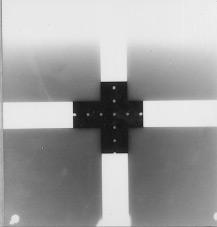 When the balls are positioned over one another and at a right angle to the film, their images will appear as one if the central ray is truly perpendicular to the film.