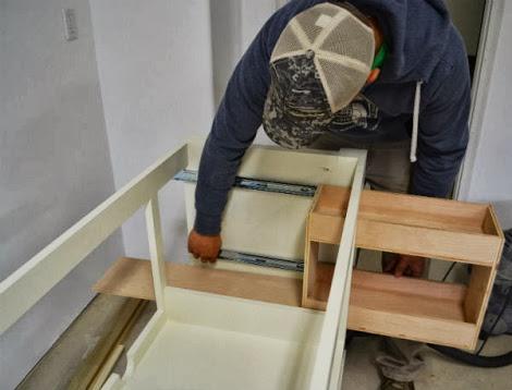 And then carefully pulled the drawer out, extending the slides, leaving the cabinet member part of the
