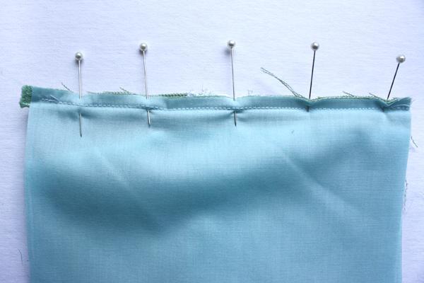 the front piece to the zipper and sew along the edge.