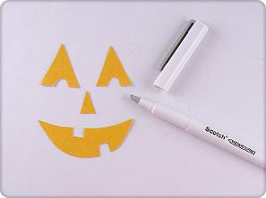 3. Draw a jack-o-lantern face on the wrong side of the glittery yellow cardstock. 4. Cut out the face using Scotch Precision Cutter. 5.