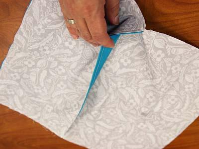 Press the seam and top stitch a 1/8" seam along the folded edge.