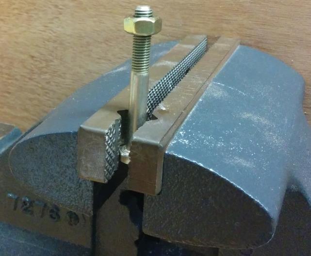 Figure 5 Threaded fastener clamped on table vise. 2) Use a 0-75 in-lb. dial type torque wrench with 7/16 socket.