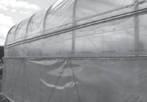 This assembly runs the length of the frame and serves as the center pipe that the roll-up cover wraps around when it is opened to ventilate the shelter.