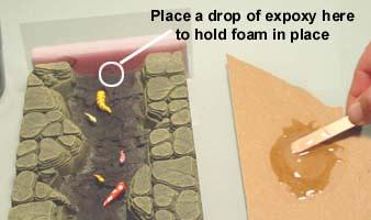 Get your strips of foam and place a piece of clear packaging tape on each piece of foam. Try to line the bottom of the tape up with the bottom of the foam.