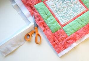 When the quilting is all finished, use a scissor to trim away all that extra