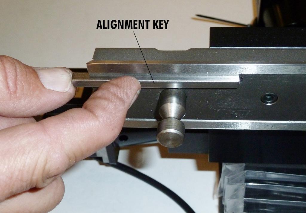 Fig. 13 Placing the alignment key into its slot in the bed. 14. Mount the headstock and stepper motor assembly onto the Grinder Bed.