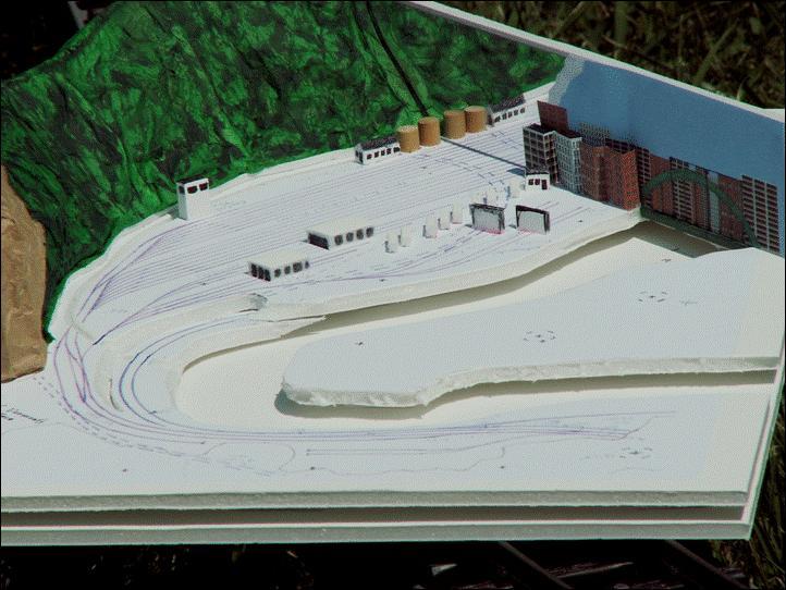 To visualize what this scene might look like, a planning model was created out of foam core board and paper, and included the