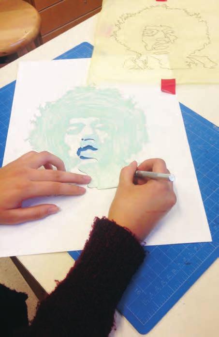 Students should use one colored pencil to identify the positive space in their self-portrait and another colored pencil for the negative space.