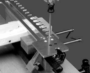 Secure the pin board by clamping it between the offset and straight clamping blocks (Fig. 16E).