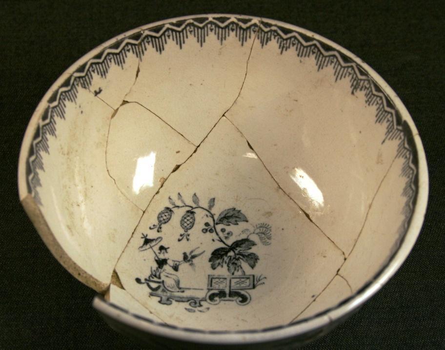 shards conjoining to form an almost complete carinated bowl, decorated with black