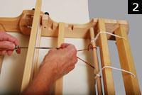 Step 5: Using the heddle hook, pull a loop of yarn through a slot in the heddle beginning 4 1/4 from the edge of the heddle. (fig.