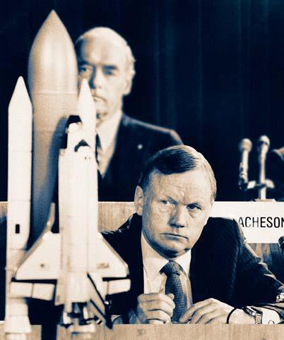 Neil Armstrong: Later Years Below: Neil Armstrong (front by shuttle model) served on the committee to investigate the 1986 space shuttle Challenger explosion (inset).