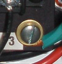 8. Route the main power wire through the bottom hole on the enclosure. 9. If input power is balanced (i.e. both live wires are 110 V out of phase) connect both live wires in any sequence to the terminal block location where L1 and L2 were connected.