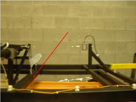 With one person on each yellow handle, lift the drive assembly onto the top of the tank. Set the assembly into the brackets located on the tank ends.