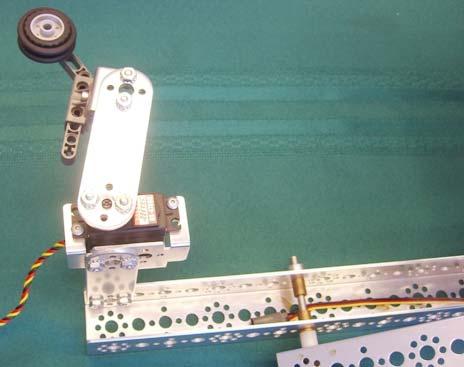 Before screwing in the self-tapping screw, make sure the range of motion of the servo is such that, at one end of its range, the arm is at about 90 degrees to the top bar.