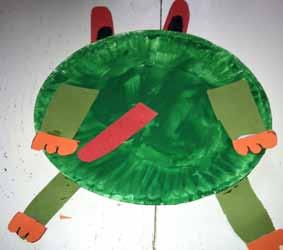 Step 3: Cut out four green legs with orange feet and glue