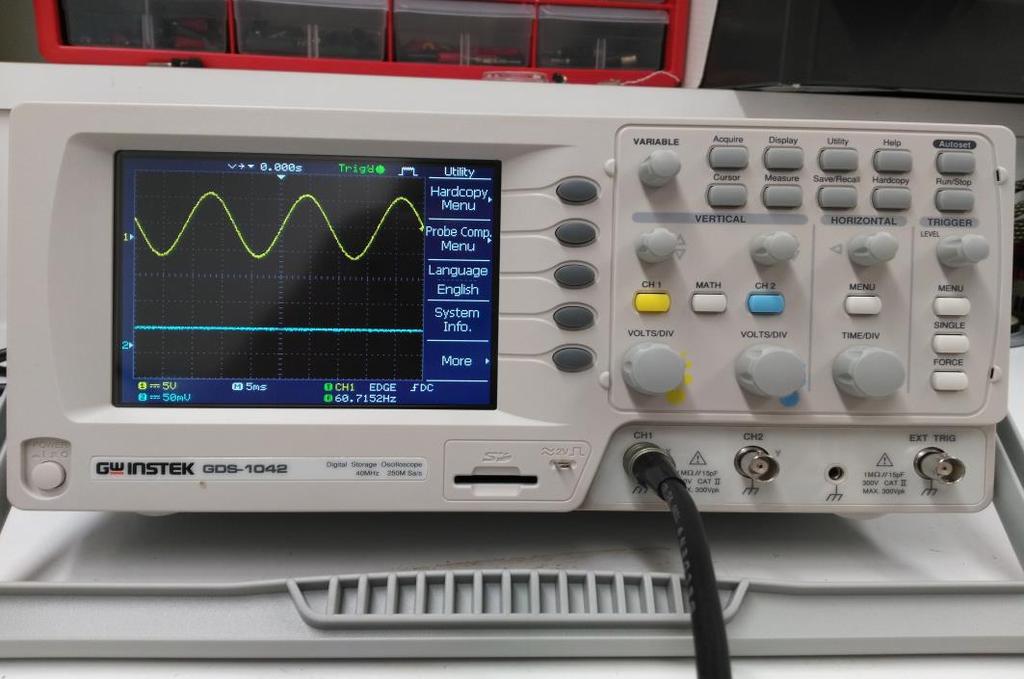 Figure 5: Our GW Instek Oscilloscope displaying a 60Hz Sine Wave. 5) Turn the knob under CH1 titled Volts/Div. This changes the scaling of the Y-Axis. 6) Turn the knob above CH1 with the two arrows.