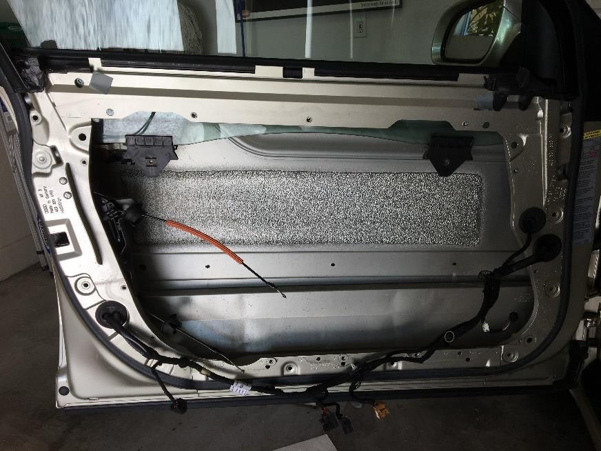 13. With the two motors removed, you can pull the cable harness along the bottom away from the aluminum door panel.