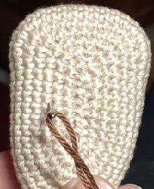 Now thread sturdy yarn in a needle and insert at the first marker