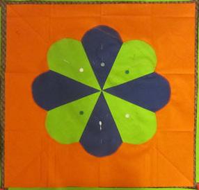 Sew the completed Petal Pattern design to Orange Square. 4. Cut four 2 x 17½ Green strips and four 5 x 17½ Turquoise strips.