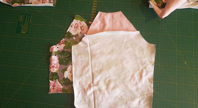 I usually start with stitching the sleeves to the front piece and then stitch the back piece to the right