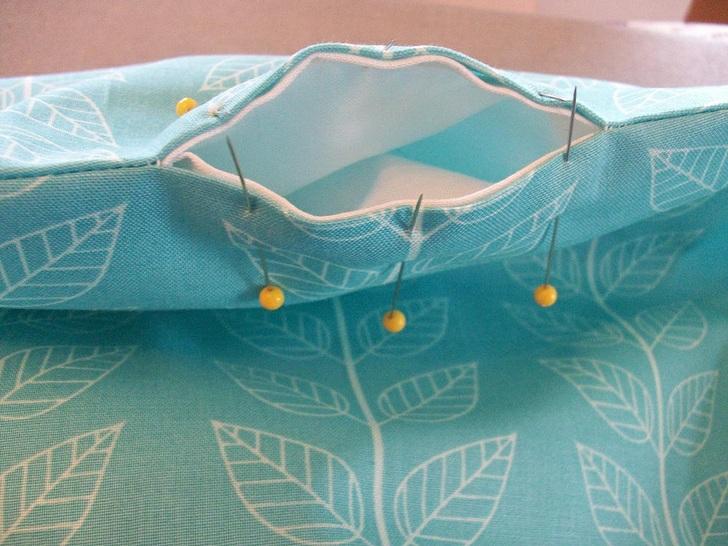 The two pieces are now wrong sides together. Line up the side seams and the hanger openings.
